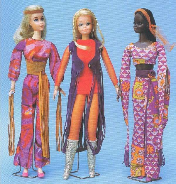 Three Barbie dolls stand donned in 1970s-style hippie attire